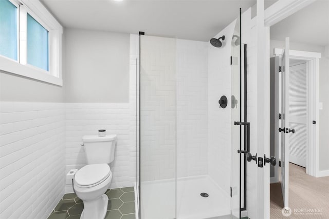 1536 NW 100th St, Seattle, WA 98177 - bathroom featuring a stall shower, toilet, tile walls, and a wainscoted wall