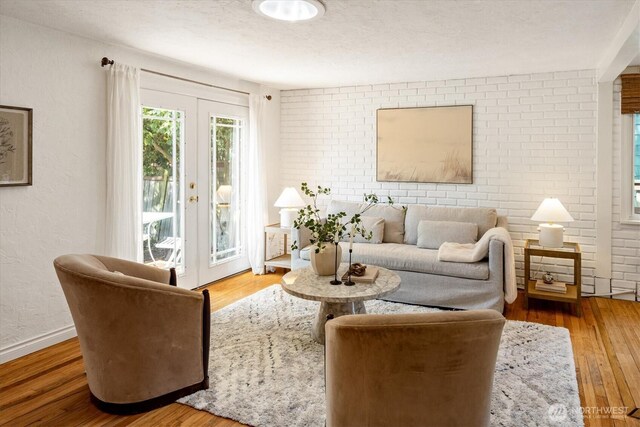 9010 13th Ave SW, Seattle, WA 98106 - living room featuring wood finished floors, french doors, and baseboards