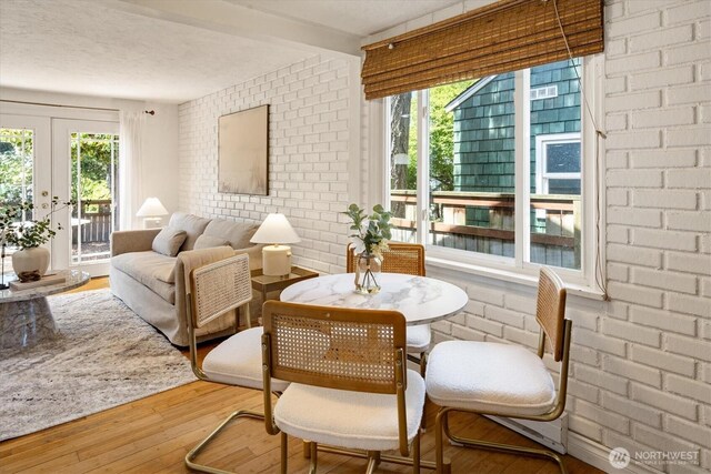9010 13th Ave SW, Seattle, WA 98106 - sitting room with brick wall, wood finished floors, and french doors