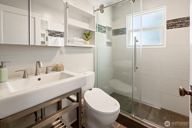 9010 13th Ave SW, Seattle, WA 98106 - full bathroom featuring toilet, a shower stall, vanity, tasteful backsplash, and tile walls