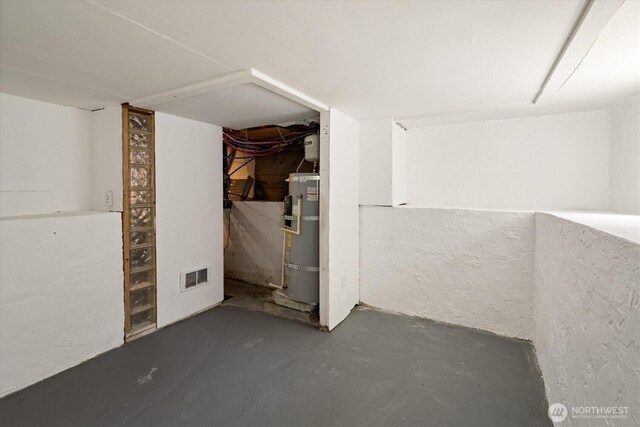 9010 13th Ave SW, Seattle, WA 98106 - unfinished below grade area featuring secured water heater and a textured wall