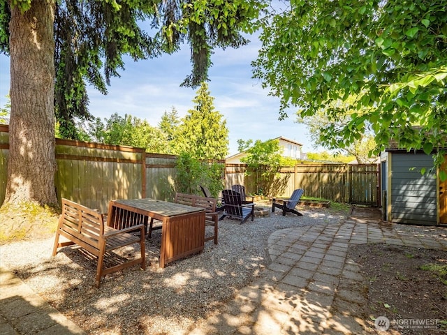 9010 13th Ave SW, Seattle, WA 98106 - fenced backyard featuring a patio and an outdoor fire pit