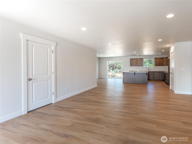 10 Salmon Dr, Wenatchee, WA 98801 - unfurnished living room featuring recessed lighting, light wood-style floors, baseboards, and a sink