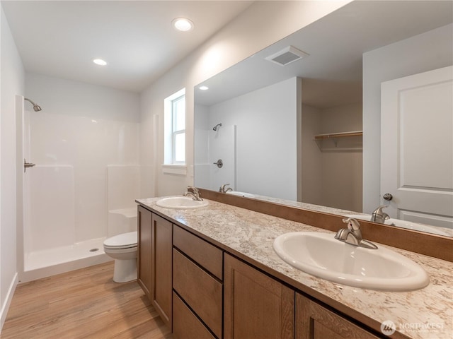 10 Salmon Dr, Wenatchee, WA 98801 - full bathroom featuring a shower, wood finished floors, toilet, double vanity, and recessed lighting