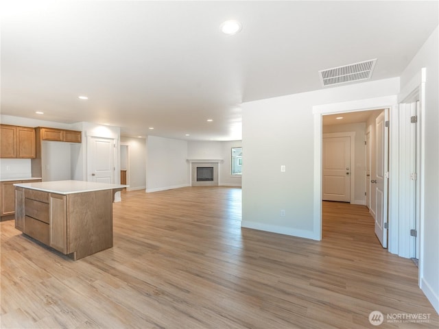 10 Salmon Dr, Wenatchee, WA 98801 - kitchen with recessed lighting, light wood finished floors, brown cabinets, light countertops, and baseboards