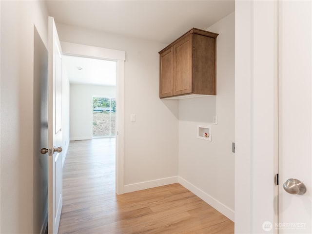 10 Salmon Dr, Wenatchee, WA 98801 - washroom with washer hookup, light wood-style flooring, cabinet space, and baseboards