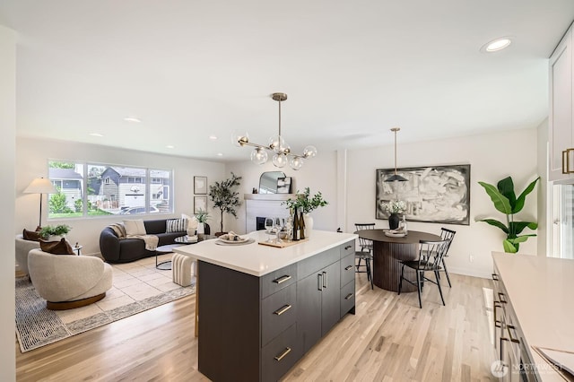 21602 49th Pl W, Mountlake Terrace, WA 98043 - kitchen with light countertops, light wood finished floors, a center island, decorative light fixtures, and recessed lighting