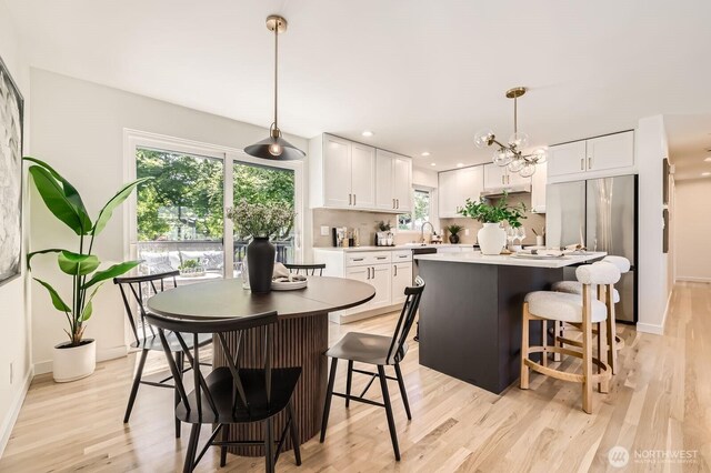 21602 49th Pl W, Mountlake Terrace, WA 98043 - dining space with light wood-type flooring, baseboards, a chandelier, and recessed lighting