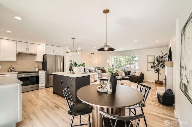 21602 49th Pl W, Mountlake Terrace, WA 98043 - dining area featuring light wood-style flooring, recessed lighting, baseboards, and a chandelier