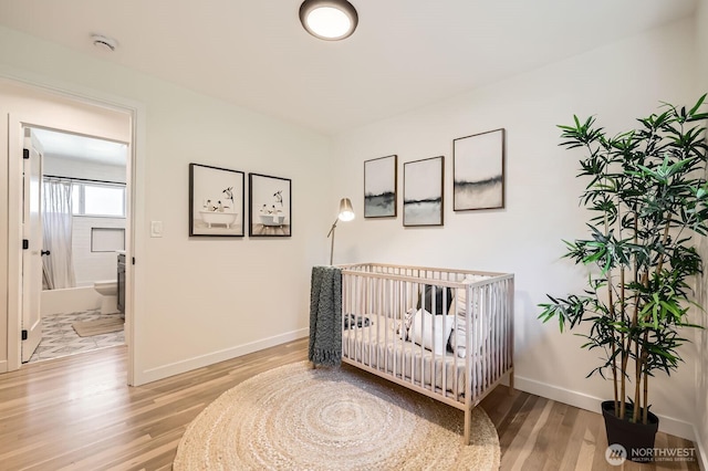21602 49th Pl W, Mountlake Terrace, WA 98043 - bedroom featuring light wood-style floors, baseboards, and a crib