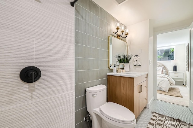 21602 49th Pl W, Mountlake Terrace, WA 98043 - full bath with vanity, tile walls, ensuite bathroom, toilet, and tile patterned floors