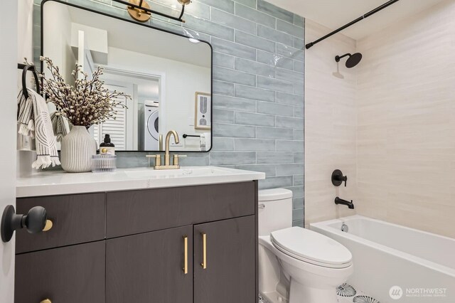 21602 49th Pl W, Mountlake Terrace, WA 98043 - full bathroom with tile walls, estacked washer and dryer, vanity, toilet, and tub / shower combination