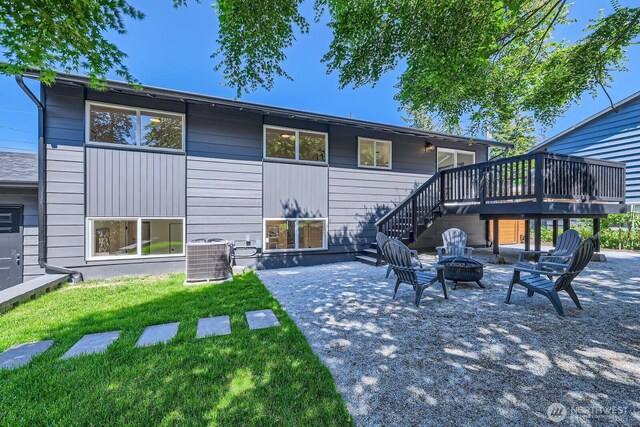 21602 49th Pl W, Mountlake Terrace, WA 98043 - rear view of house featuring an outdoor fire pit, cooling unit, a wooden deck, a lawn, and a patio