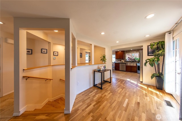 204 76th St SE, Everett, WA 98203 - corridor with light wood finished floors, recessed lighting, baseboards, and an upstairs landing