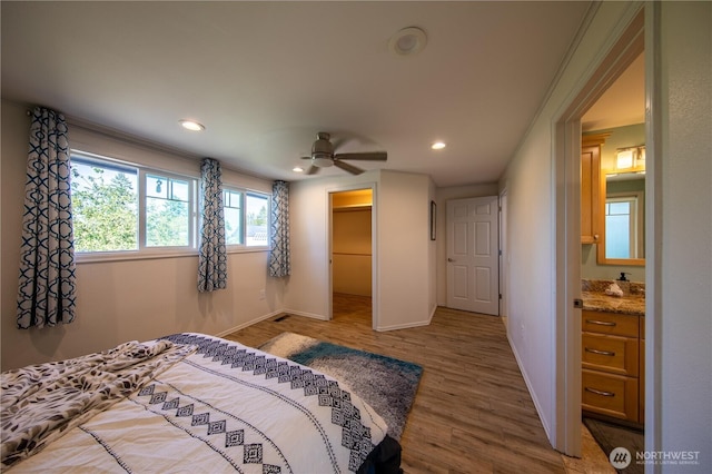 204 76th St SE, Everett, WA 98203 - bedroom with wood finished floors, recessed lighting, baseboards, a spacious closet, and a closet