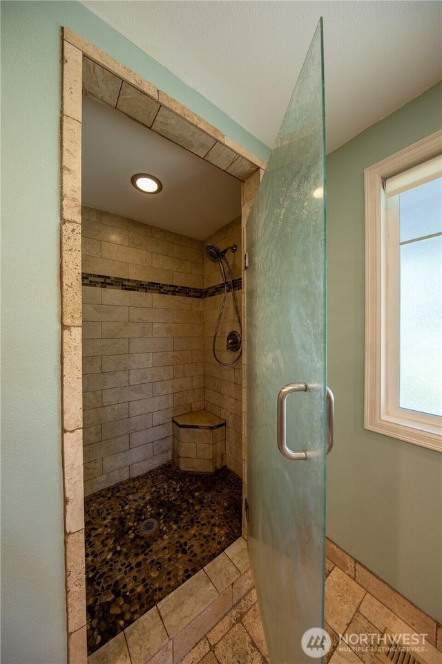 204 76th St SE, Everett, WA 98203 - bathroom featuring a shower stall, healthy amount of natural light, and stone tile floors