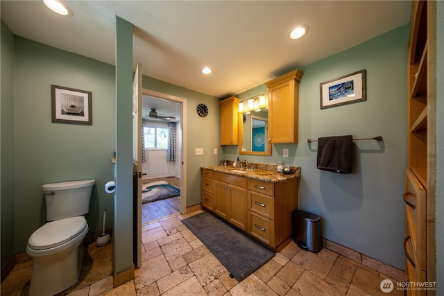 204 76th St SE, Everett, WA 98203 - full bathroom with stone tile flooring, vanity, toilet, baseboards, and recessed lighting