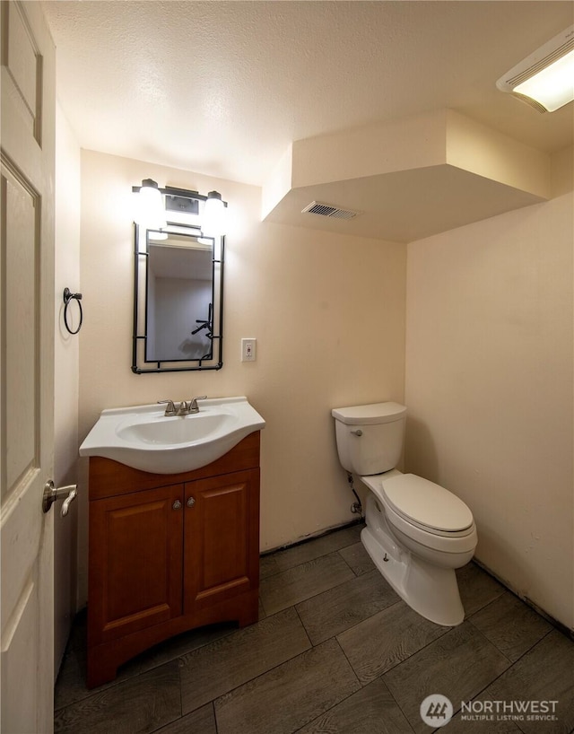 204 76th St SE, Everett, WA 98203 - half bathroom with toilet, vanity, and wood tiled floors