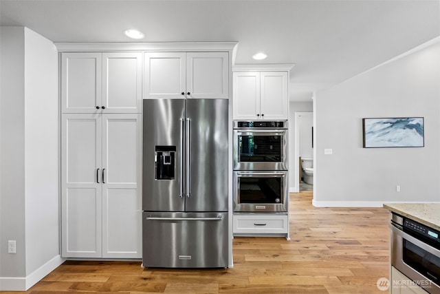 52 Chapman Loop Unit D, Steilacoom, WA 98388 - kitchen with stainless steel appliances, baseboards, white cabinetry, recessed lighting, and light wood-style flooring