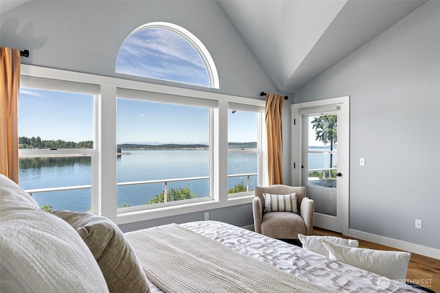 52 Chapman Loop Unit D, Steilacoom, WA 98388 - bedroom with a water view, wood finished floors, lofted ceiling, baseboards, and access to exterior