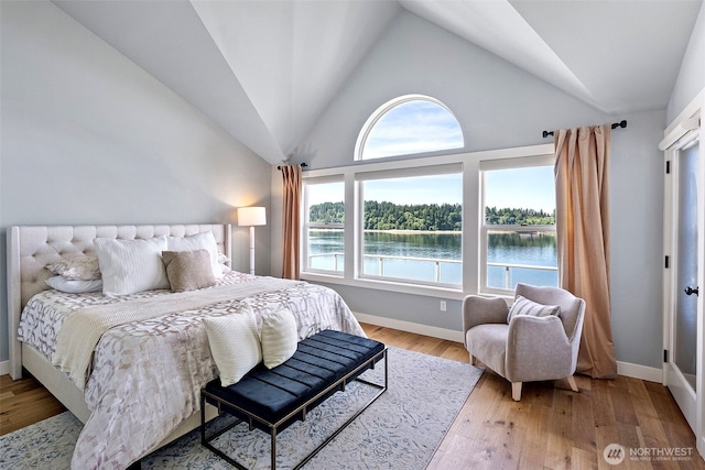52 Chapman Loop Unit D, Steilacoom, WA 98388 - bedroom with vaulted ceiling, a water view, baseboards, and light wood finished floors