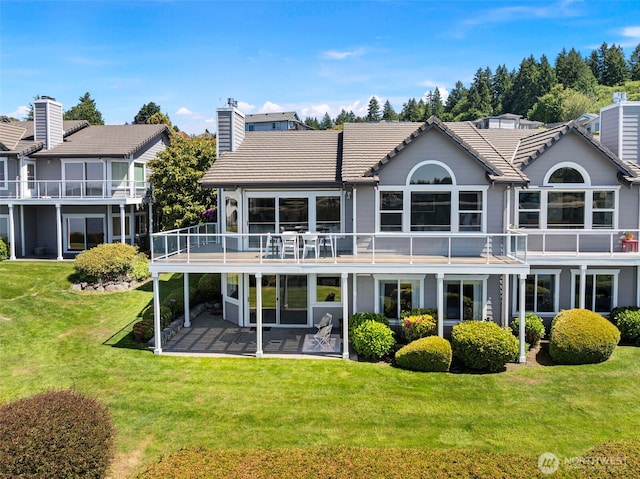 52 Chapman Loop Unit D, Steilacoom, WA 98388 - back of property with a chimney, a patio area, a lawn, and a tile roof