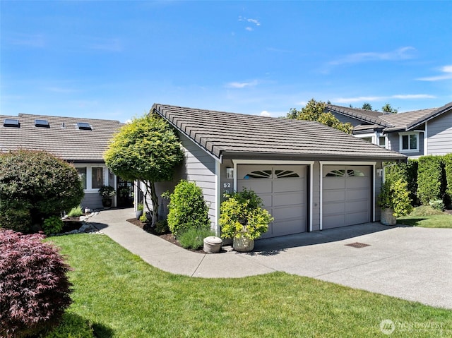 52 Chapman Loop Unit D, Steilacoom, WA 98388 - view of front of home featuring a tiled roof, driveway, a front yard, and a garage