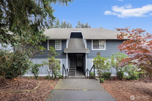 5822 N 35th St Unit C9, Tacoma, WA 98407 - view of front of house with a shingled roof and stairs