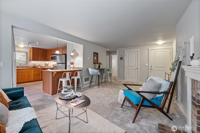 5822 N 35th St Unit C9, Tacoma, WA 98407 - living area featuring a brick fireplace and light colored carpet