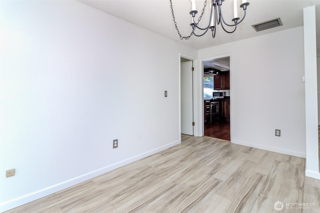 32622 39th Ave SW, Federal Way, WA 98023 - unfurnished dining area featuring a chandelier, light wood-type flooring, and baseboards