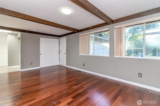 32622 39th Ave SW, Federal Way, WA 98023 - empty room with a textured ceiling, beamed ceiling, plenty of natural light, and baseboards