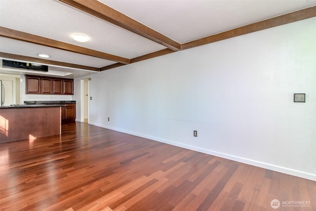 32622 39th Ave SW, Federal Way, WA 98023 - unfurnished living room featuring beamed ceiling, dark wood finished floors, and baseboards