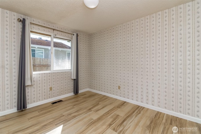 32622 39th Ave SW, Federal Way, WA 98023 - spare room with wood finished floors, a textured ceiling, and baseboards