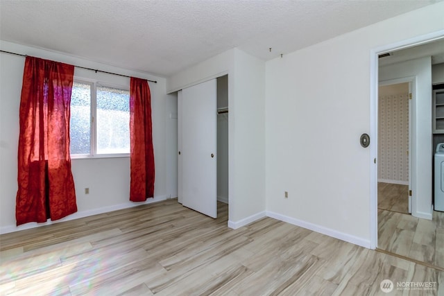 32622 39th Ave SW, Federal Way, WA 98023 - unfurnished bedroom with wood finished floors, washer / clothes dryer, a closet, baseboards, and a textured ceiling