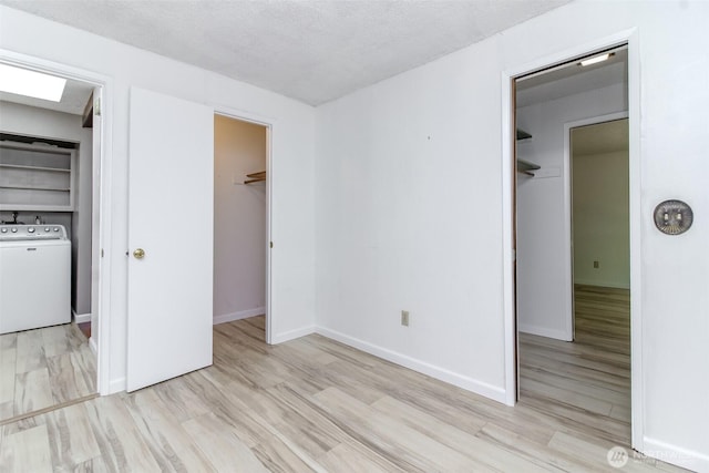 32622 39th Ave SW, Federal Way, WA 98023 - unfurnished bedroom featuring a spacious closet, washer / dryer, a closet, wood finished floors, and baseboards