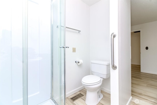 32622 39th Ave SW, Federal Way, WA 98023 - bathroom featuring toilet, a shower stall, wood finished floors, and baseboards