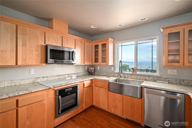 1257 Canterbury Ln, Oak Harbor, WA 98277 - kitchen featuring appliances with stainless steel finishes, a sink, dark wood-style flooring, light stone countertops, and glass insert cabinets