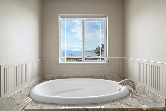 1257 Canterbury Ln, Oak Harbor, WA 98277 - full bath featuring a garden tub, healthy amount of natural light, and a wainscoted wall