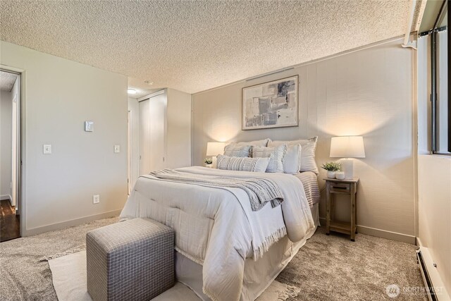 6268 137th Pl NE Unit 244, Redmond, WA 98052 - bedroom featuring baseboard heating, carpet, a textured ceiling, and baseboards