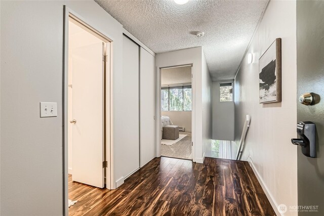 6268 137th Pl NE Unit 244, Redmond, WA 98052 - hall with wood finished floors, a textured ceiling, and baseboards