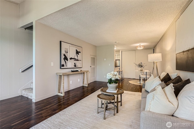 6268 137th Pl NE Unit 244, Redmond, WA 98052 - living area featuring wood finished floors, stairs, a textured ceiling, and baseboards