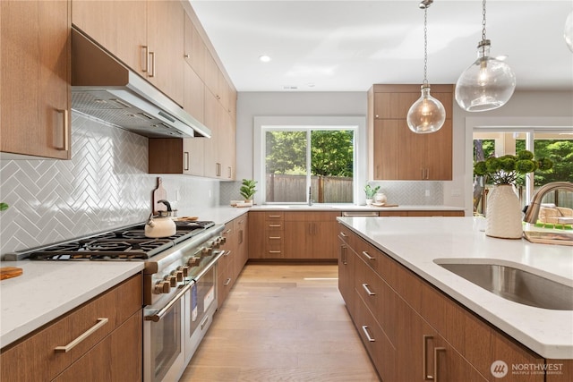 14511 SE 21st Pl, Bellevue, WA 98007 - kitchen with a sink, under cabinet range hood, range with two ovens, plenty of natural light, and recessed lighting