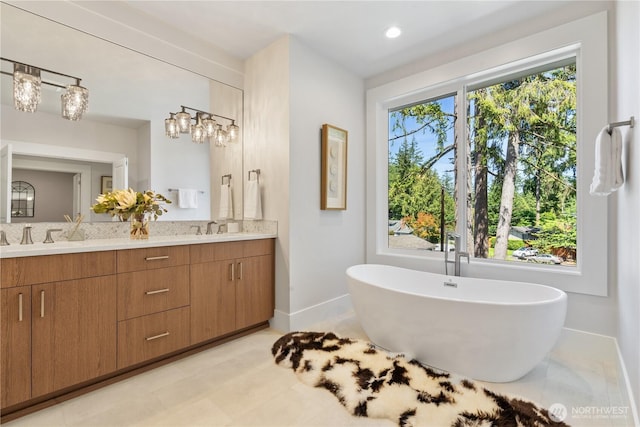 14511 SE 21st Pl, Bellevue, WA 98007 - bathroom with baseboards, double vanity, a soaking tub, backsplash, and recessed lighting