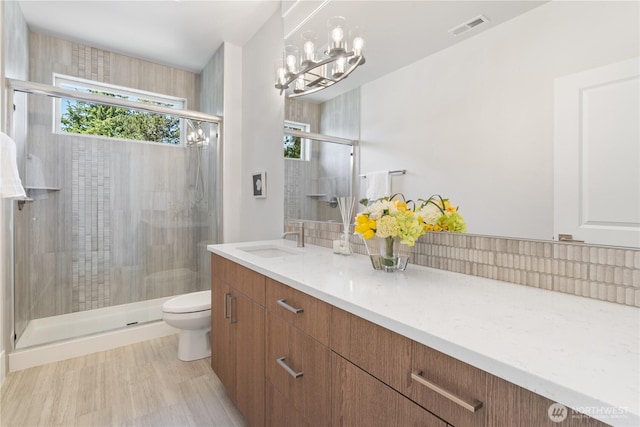 14511 SE 21st Pl, Bellevue, WA 98007 - full bath featuring toilet, vanity, a stall shower, and a chandelier