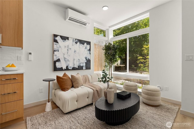 3609 Linden Ave N, Seattle, WA 98103 - living area with an AC wall unit, light wood finished floors, baseboards, and recessed lighting