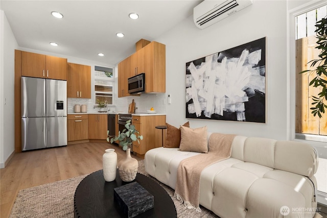 3609 Linden Ave N, Seattle, WA 98103 - living room featuring a wall mounted air conditioner, healthy amount of natural light, light wood finished floors, and recessed lighting