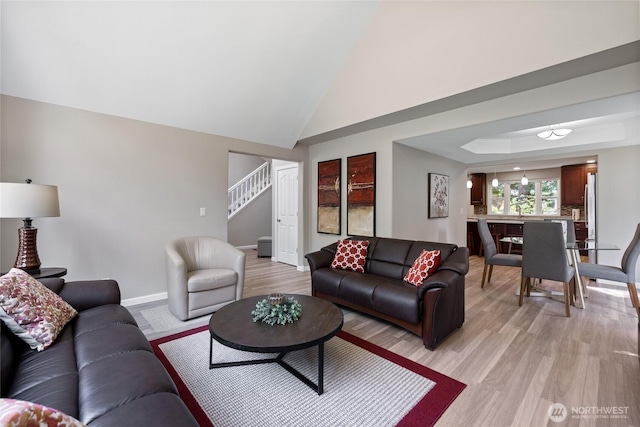 6579 Gleneagle Ave SW, Port Orchard, WA 98367 - living area featuring stairs, light wood-style flooring, baseboards, and lofted ceiling