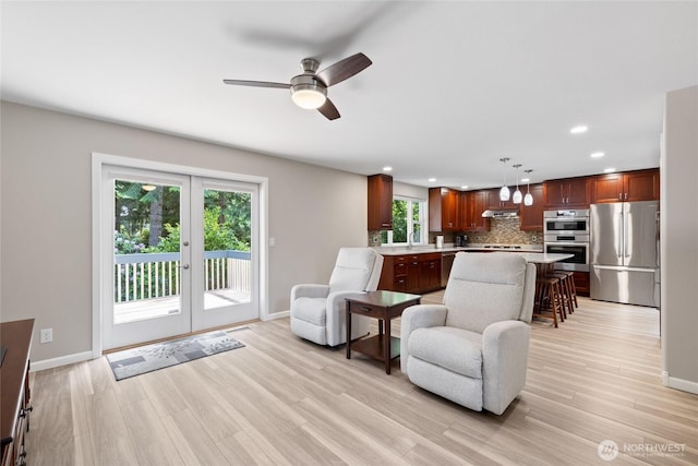 6579 Gleneagle Ave SW, Port Orchard, WA 98367 - living room with baseboards, ceiling fan, light wood-style flooring, recessed lighting, and french doors