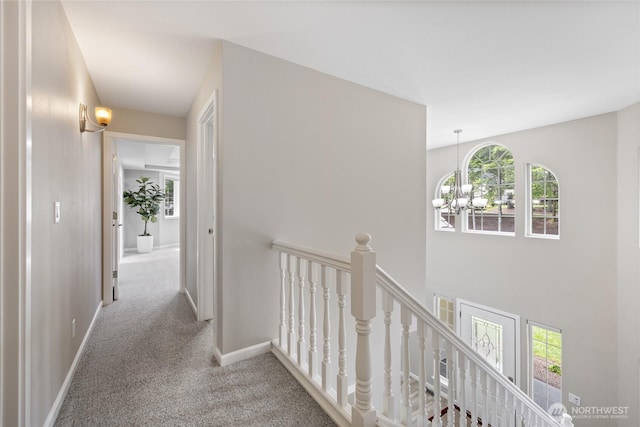 6579 Gleneagle Ave SW, Port Orchard, WA 98367 - hallway featuring an upstairs landing, carpet flooring, a chandelier, and baseboards