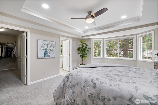 6579 Gleneagle Ave SW, Port Orchard, WA 98367 - bedroom with a tray ceiling, light carpet, a spacious closet, baseboards, and crown molding